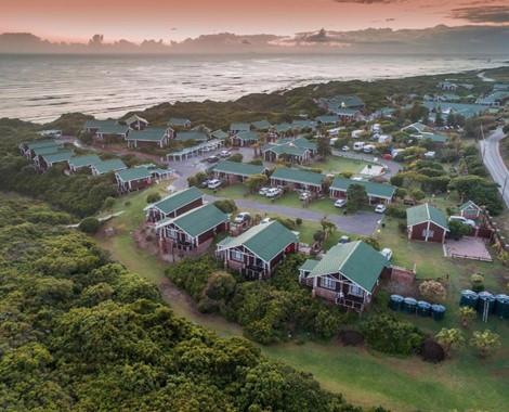 Imagine perfectly situated timber cabins merging with a coastal landscape. Imagine awaking to the sound of the ocean each morning
